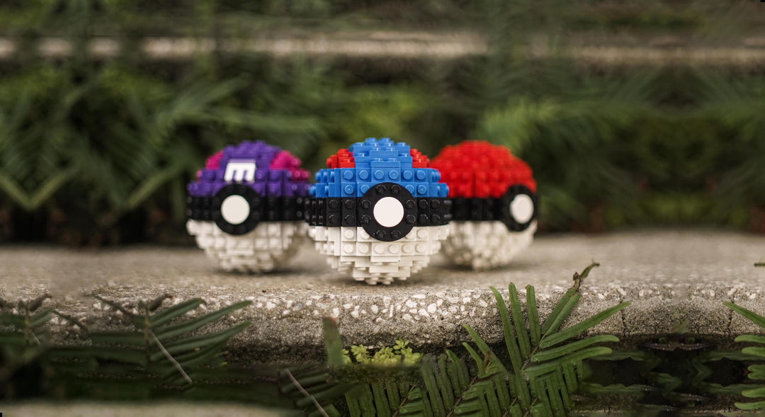 Poké Ball life-sized replicas in LEGO bricks on jungle ledge